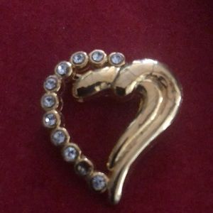 Gold tone heart with rhinestones.